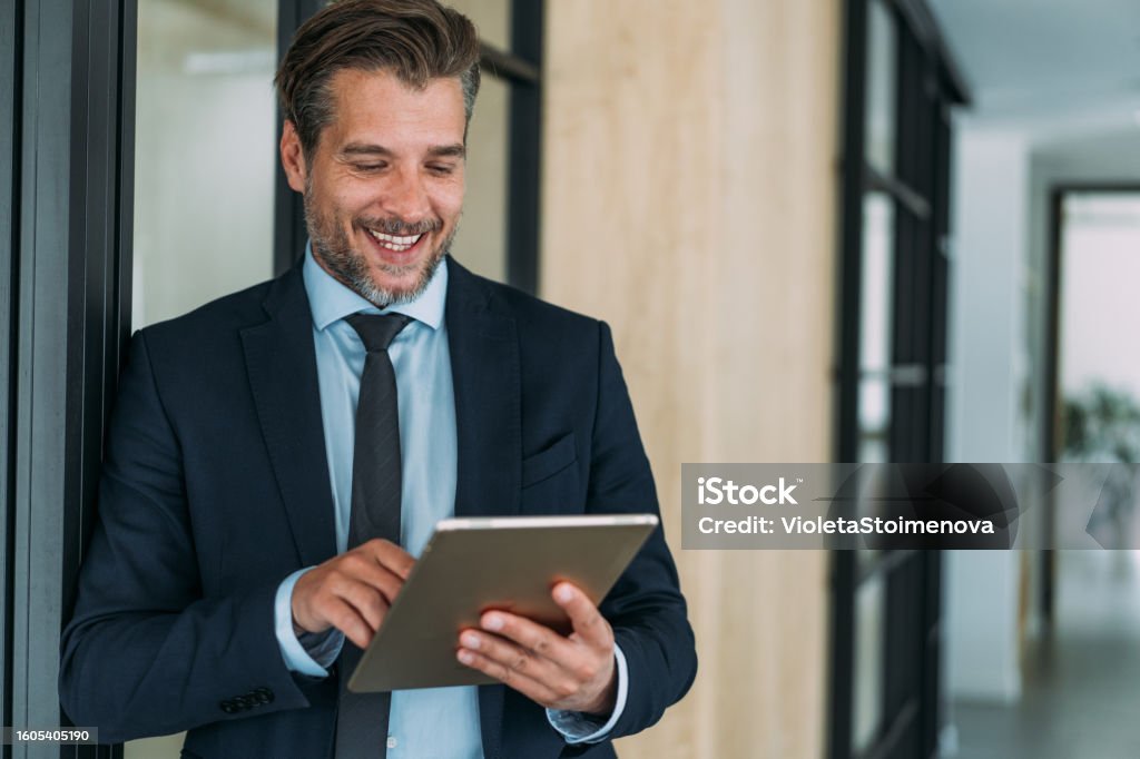 Shot of a handsome businessman using digital tablet in the office.